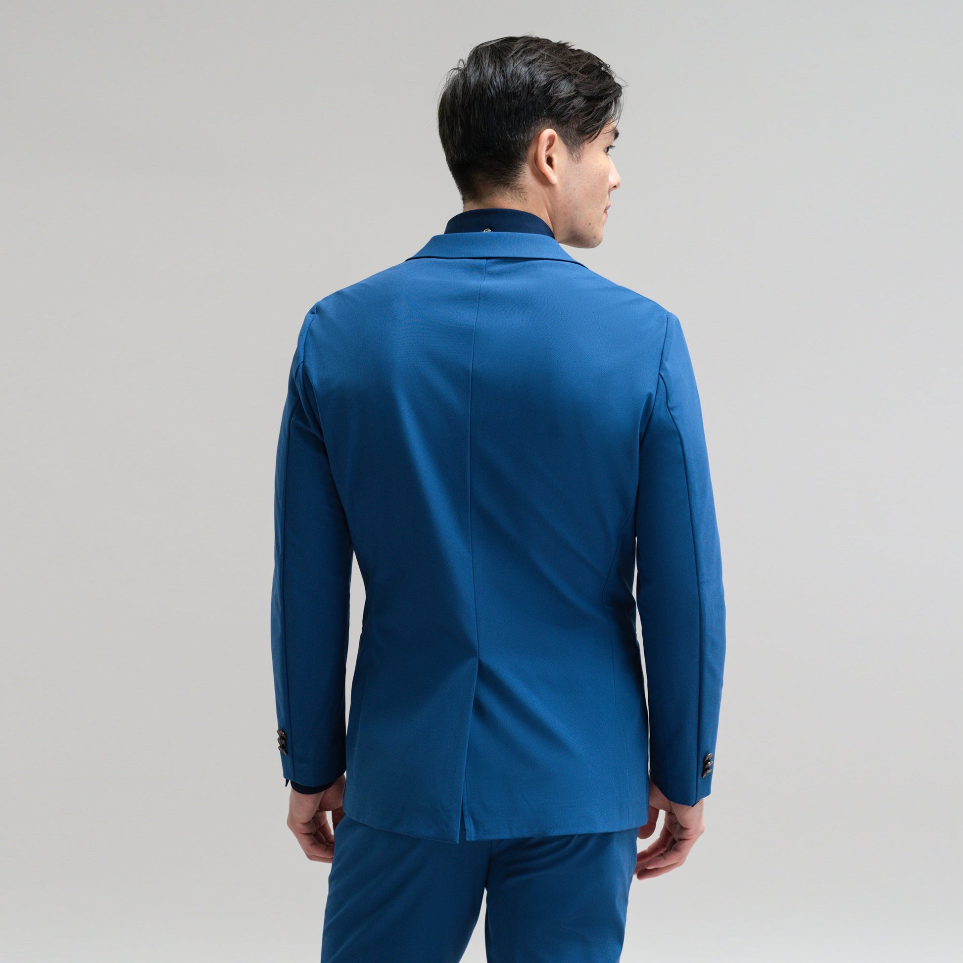 Bespoke custom athleisure technical athletic stretch suit los angeles model Jesse in Italian Blue